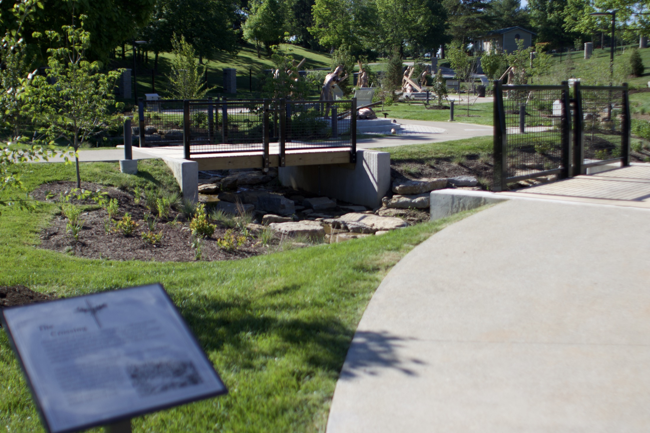 A stone footbridge crossing a small stream along the Stations path.